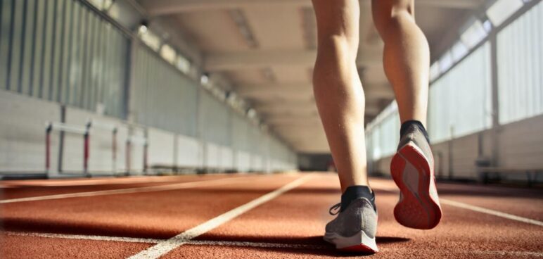 Picture of a person jogging in an indoor stadium